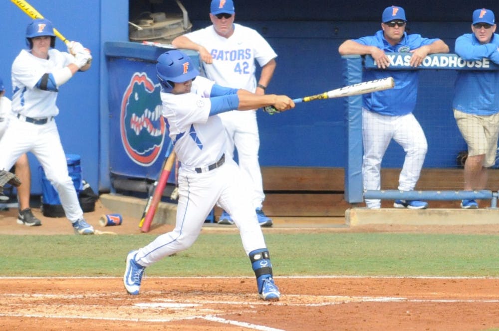 Nelson Maldonado follows through on his swing during Florida's 12-3 win against Florida Gulf Coast on Feb. 21, 2016, at McKethan Stadium. 