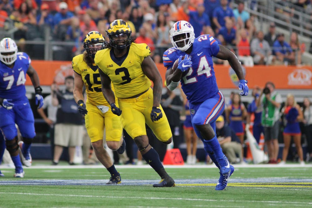 <p>UF running back Mark Thompson runs for a touchdown only for it to be called back due to a penalty during Florida's 33-17 loss to Michigan on Saturday at AT&amp;T Stadium in Arlington, Texas.</p>
