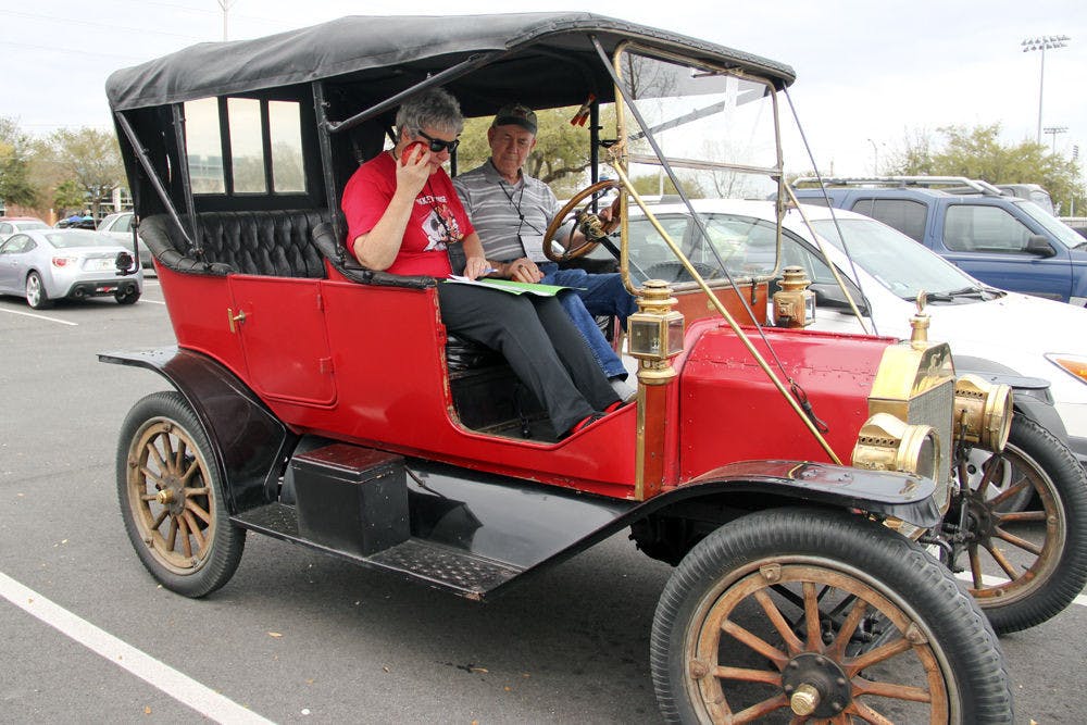 Barbara Revaz and Willard Revaz of Oxford, Connecticut, drive their vintage car as part of the the vintage car winter tour that visited Gainesville in the parking lot near the Florida Museum of Natural History on Monday afternoon. Willard said the tour began Sunday and will run until Thursday.