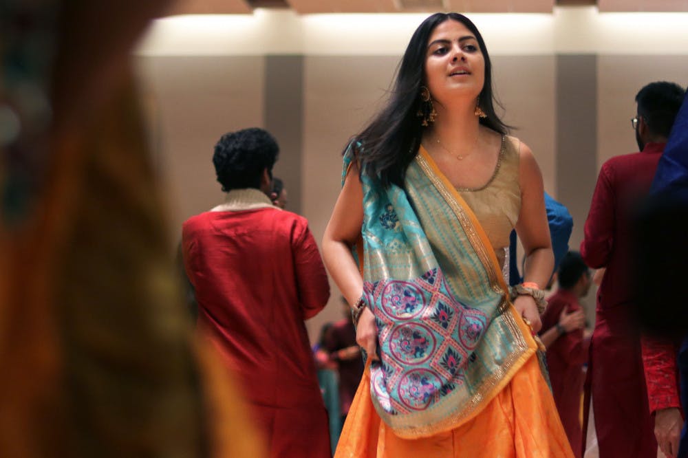 Rani LaRue, an 18-year-old exploratory major, dances with a group of people Friday night at Garba, an event thrown by the Indian Students Association at the Reitz Union Rion Ballroom.