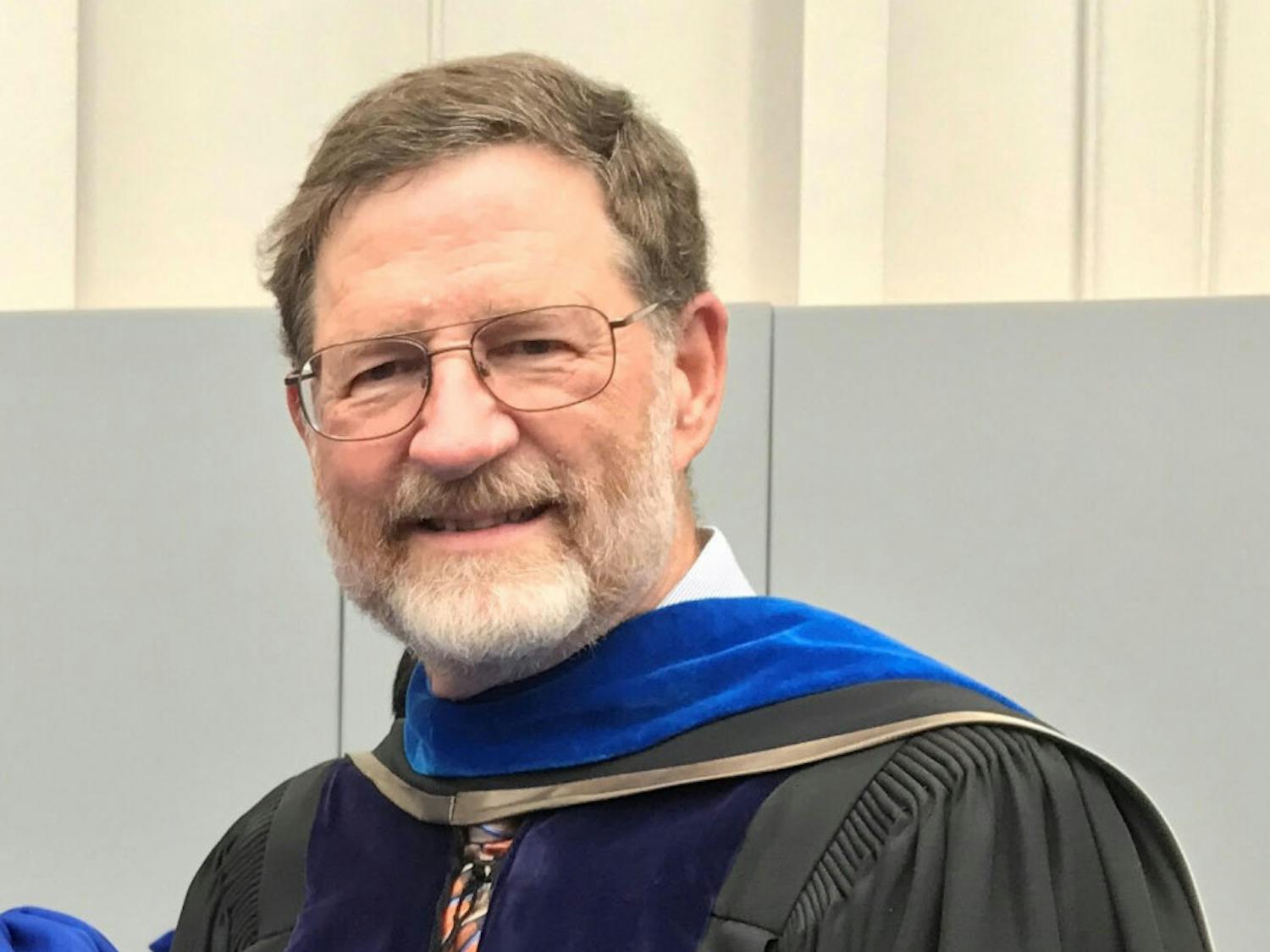 Richard Yost, 66, pictured in April 2019 at a PhD commencement ceremony where he escorted his most recent PhD graduate student.