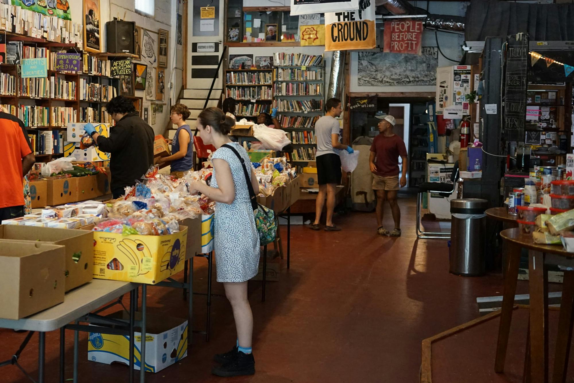 GFGS volunteers organize fresh produce and food donations in preparation for their weekly distribution at the Civic Media Center Tuesday, May 16, 2023. 