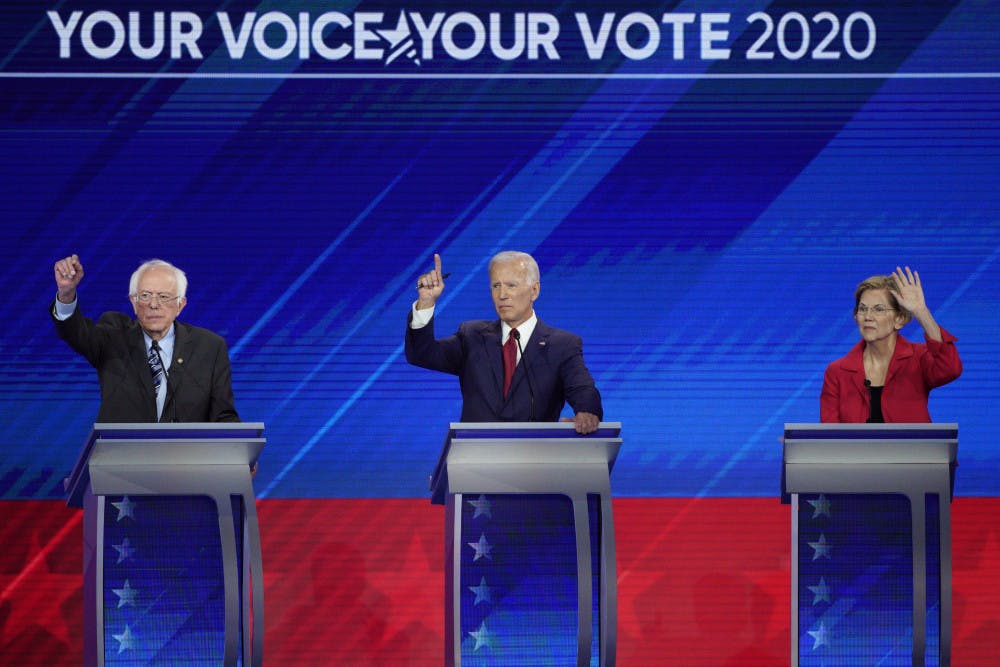 From left, Democratic presidential candidates Sen. Bernie Sanders, I-Vt., former Vice President Joe Biden and Sen. Elizabeth Warren, D-Mass. raise their hands to answer a question Thursday, Sept. 12, 2019, during a Democratic presidential primary debate hosted by ABC at Texas Southern University in Houston. (AP Photo/David J. Phillip)