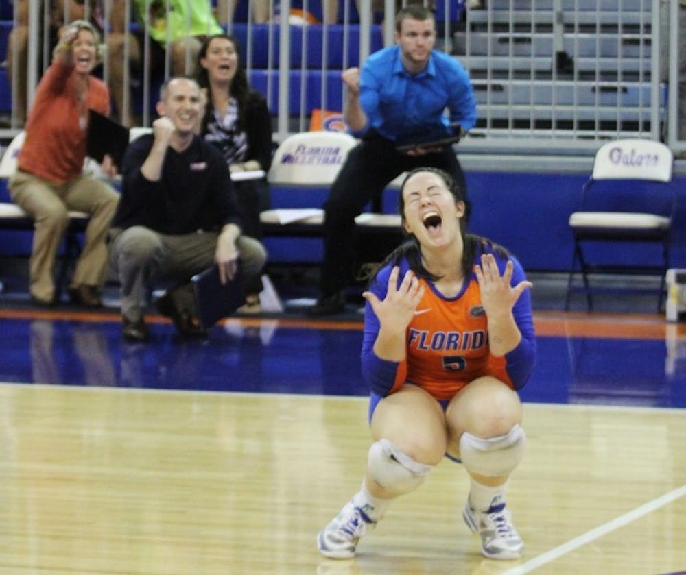<p>Libero Taylor Unroe celebrates after recording an ace in a 3-0 sweep of Missouri. The sophomore had 15 digs and 5 assists against the Tigers on Friday.</p>