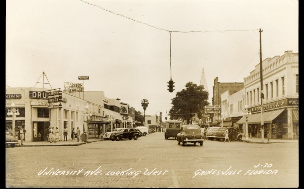 <p>A photographed undated postcard of University Avenue before the 1970s and 1980s renovations that eliminated on-street parking along the road. [Photo courtesy of the Matheson History Museum]</p>