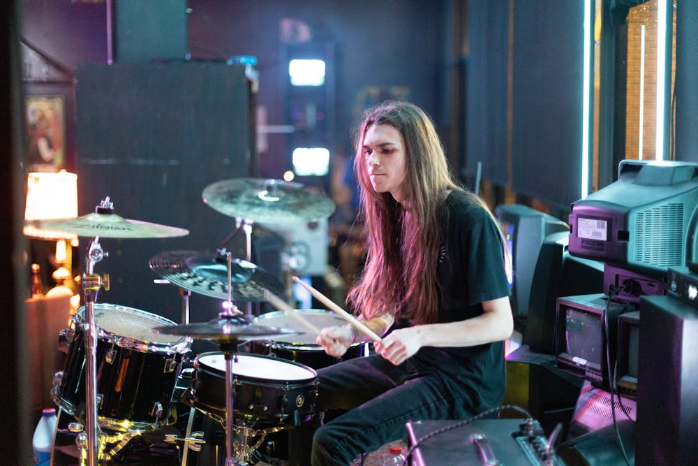 A musician plays the drums at How Bazar on Friday, July 19, 2024.