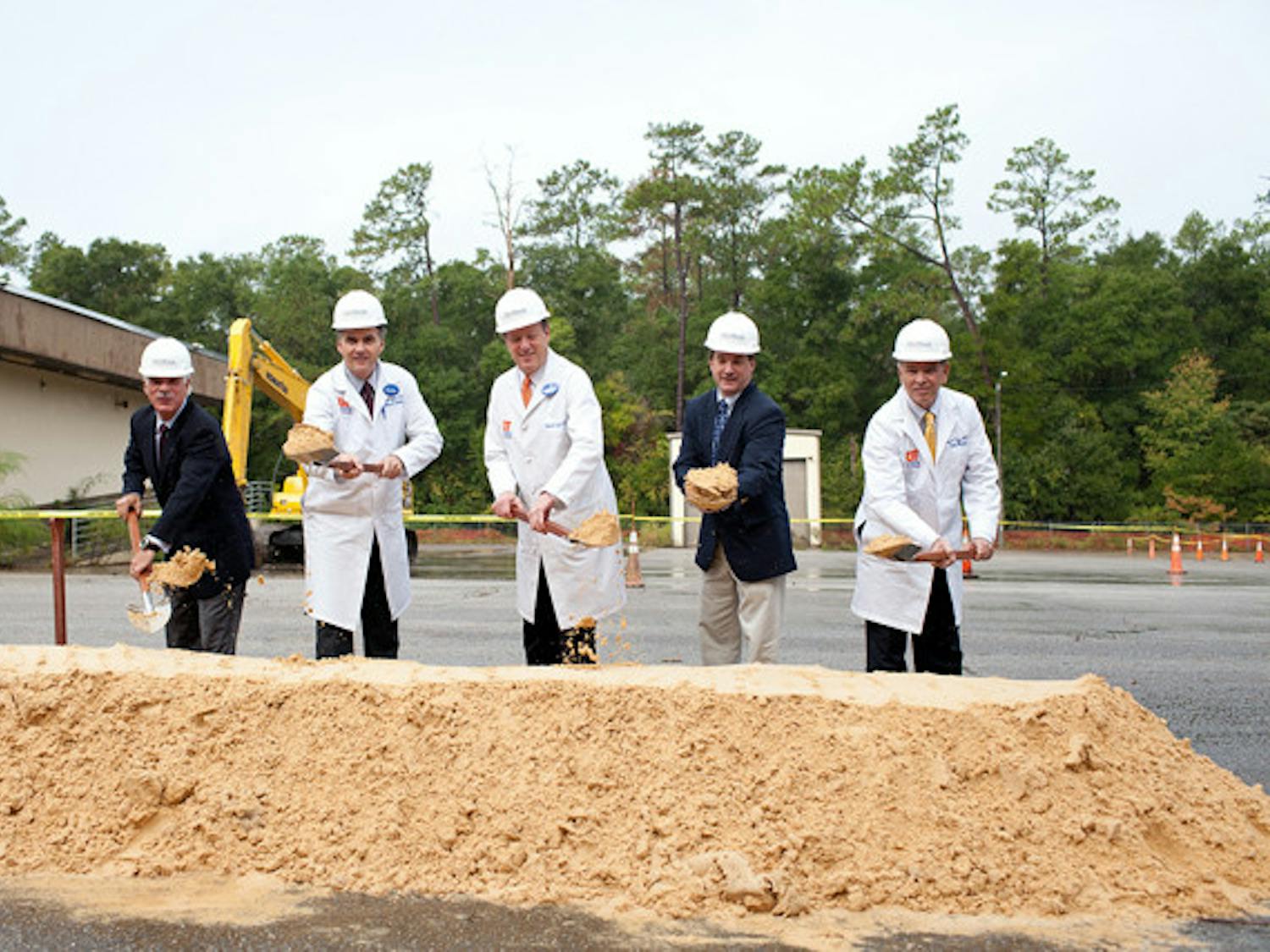 Tim Goldfarb, Shands Heatlhcare CEO; Michael Good, M.D., dean of the University of Florida College of Medicine; David Guzick, M.D., senior vice president for health affairs and president of the UF&Shands Health System; Lee Pinkoson, Alachua County Commission Chair; and Marvin A. Dewar, M.D., J.D., CEO and chief medical office of University of Florida Physicians ceremonially toss dirt at the ground breaking ceremony for the UF&Shands at Springhill campus.