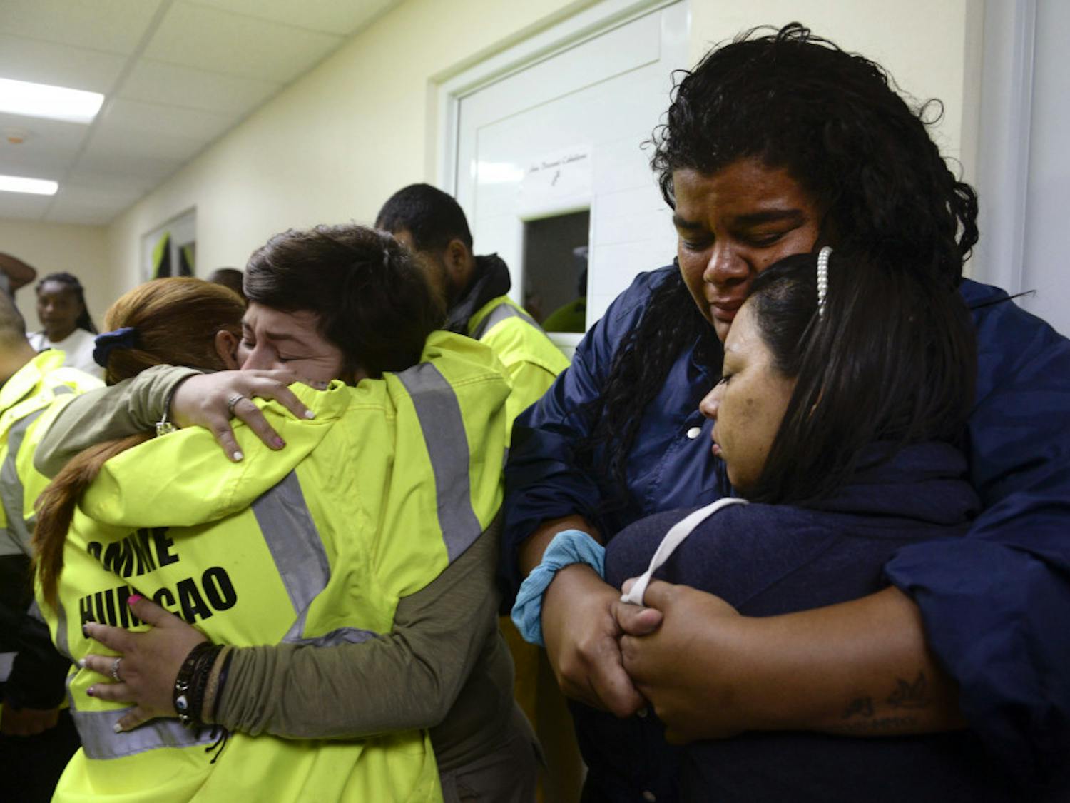 From left: Rescue team members Candida Lozada, Stephanie Rivera, Mary Rodriguez and Zuly Ruiz embrace as they wait to assist in the aftermath of Hurricane Maria in Humacao, Puerto Rico, on Wednesday.