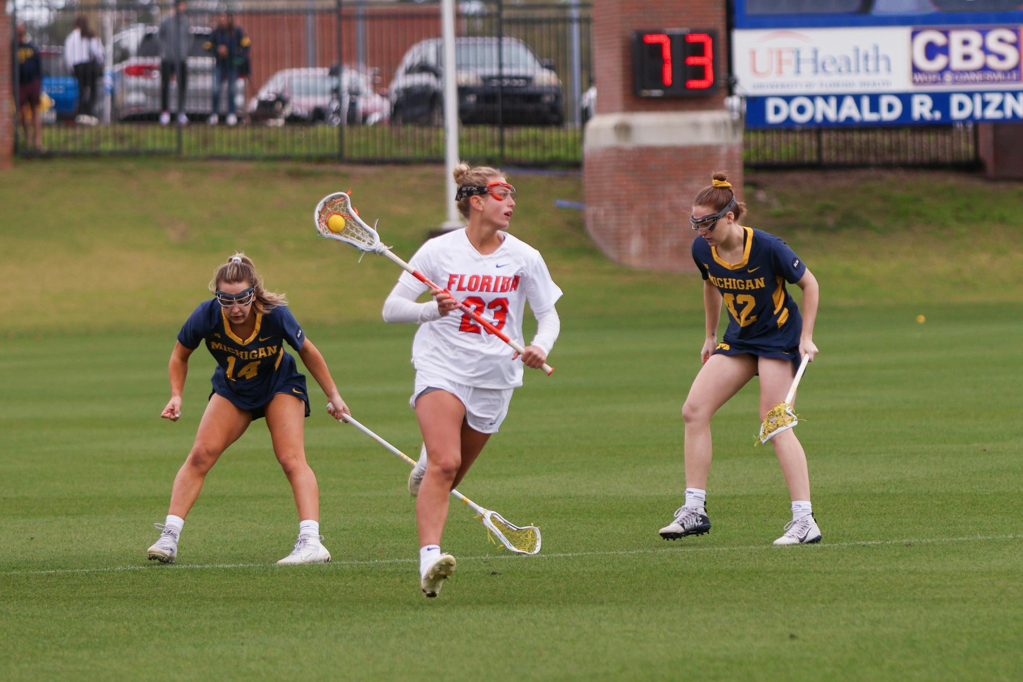 Florida defender Becky Browndorf carries the ball in her crosse during the Gators' 17-8 win against the No. 18 Michigan Wolverines Sunday, Feb. 12, 2023.