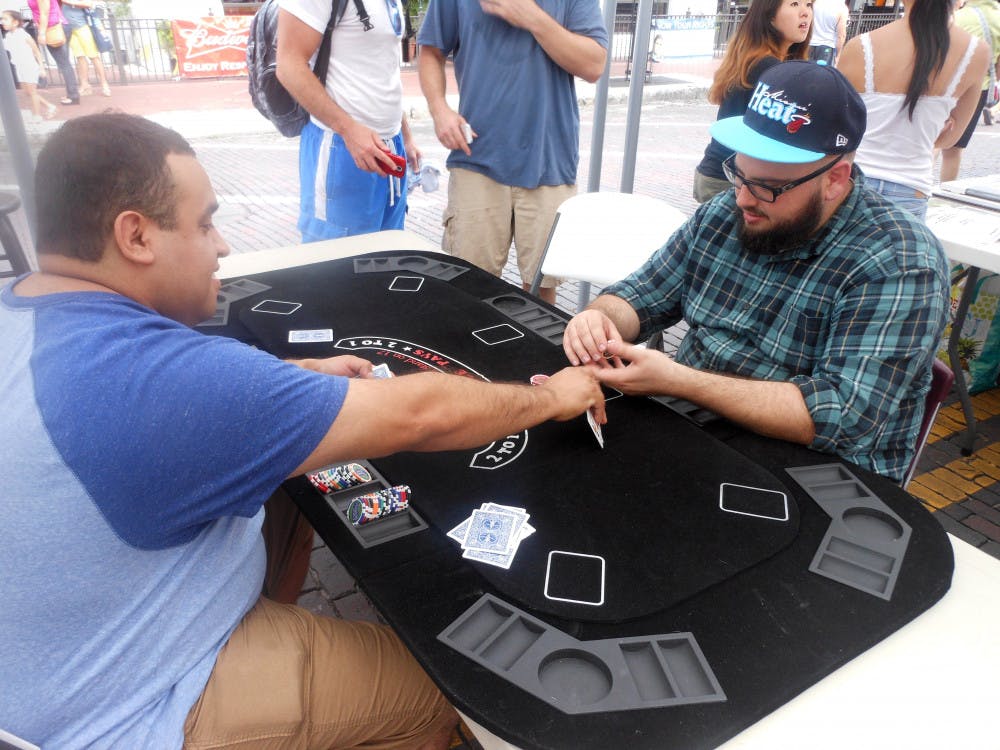 <p>Tony Espetia, client relations director for The Pledge 5 Foundation, left, and Hector Galvez play for a cause at the blackjack table during the “Viva Gainesvegas” charity event Friday evening.</p><div> </div>