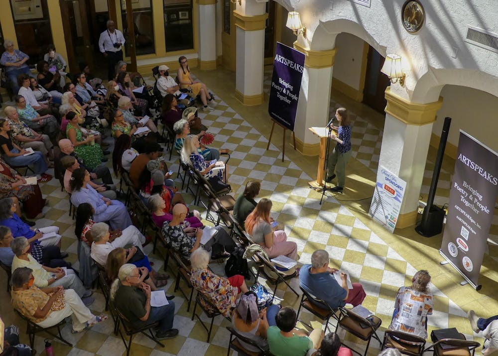 <p>Audience members at the Thomas Center listen intently to the Artspeaks poems, occasionally snapping and humming in response, on Sept. 7, 2025.</p>