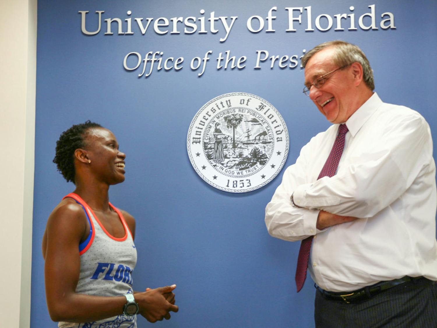 Nelly Kadag, a 30-year-old UF interdisciplinary ecology doctoral student, talks with UF President Kent Fuchs on Wednesday before completing the 22 Pushup Challenge, which educates people about veteran suicide rates. She nominated him for the challenge on Sept. 9.