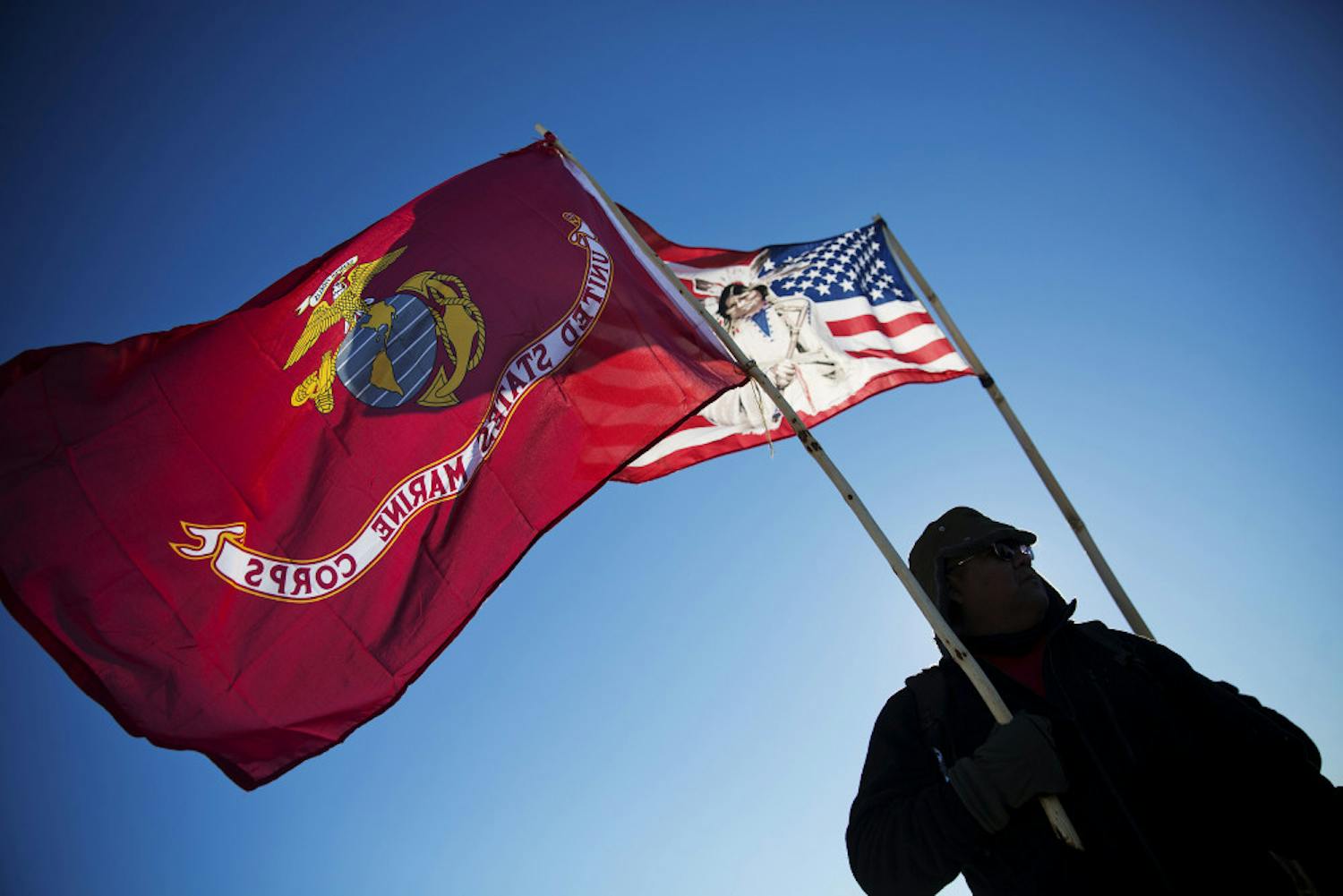 Marine Corps veteran and Northern Paiute and Pit River Native American Audie Noneo, of Susanville, Calif., holds the Marine Corps flag at the Oceti Sakowin camp where people have gathered to protest the Dakota Access oil pipeline in Cannon Ball, N.D., Sunday, Dec. 4, 2016. The U.S. Army Corps of Engineers said Sunday it won't grant easement for the Dakota Access oil pipeline in southern North Dakota.