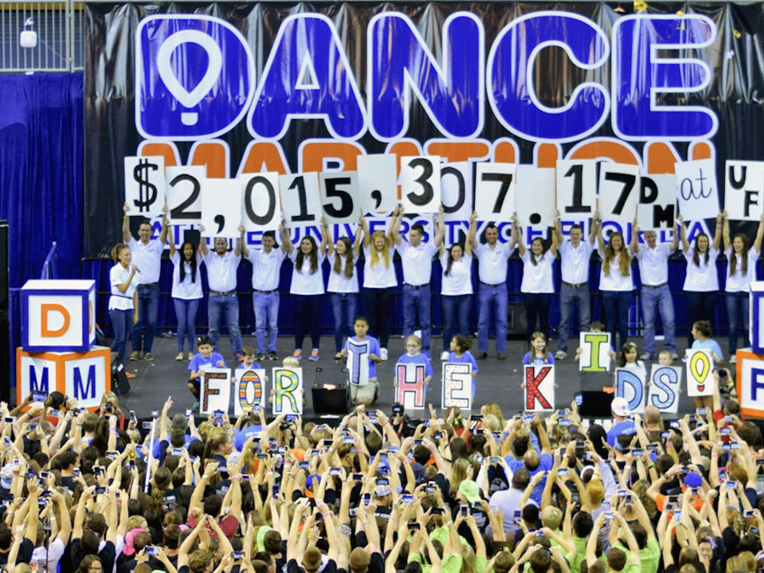 Students celebrate in the O'Connell Center on Sunday after hearing that Dance Marathon participants raised a record-breaking $2,015,307.17 to benefit UF Health Shands Children's Hospital. Dance Marathon at the University of Florida is an annual 26.2-hour event where hundreds of students stay awake and "stand for those who can't," to raise money for Children's Miracle Network Hospitals.