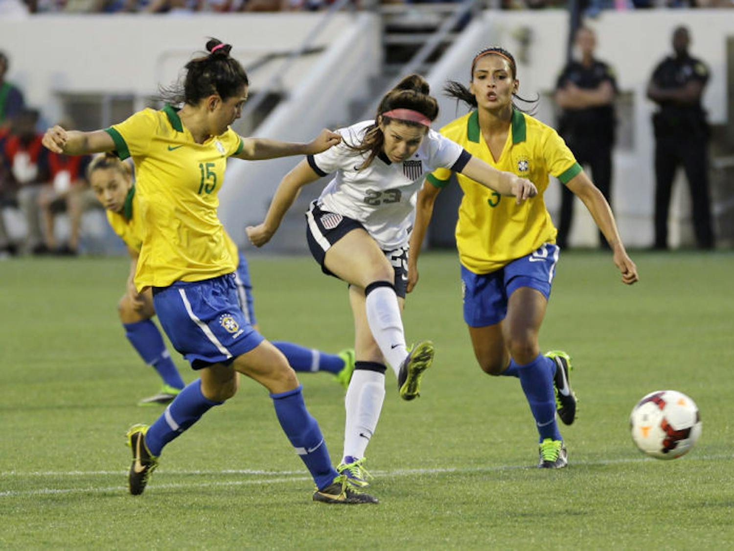 Erika Tymrak (23) scores a goal between Brazil midfielder Bia (15) and defender Calandrini (3) during a friendly soccer match in Orlando on Sunday. The U.S. Women's National Team beat Brazil 4-1.