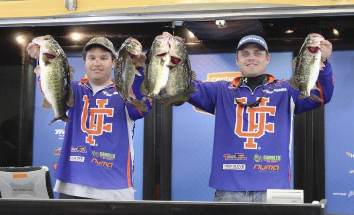 Shelby Concon (left) and Kyle Smith (right) at the South Regional qualifier holding the bass they caught that day.