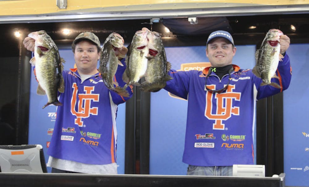 <p>Shelby Concon (left) and Kyle Smith (right) at the South Regional qualifier holding the bass they caught that day.</p>