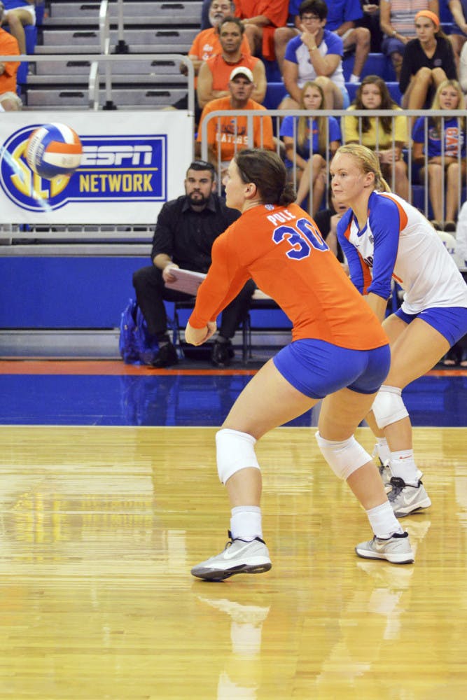 Holly Pole (30) and Maddy Monserez attempt to dig the ball during Florida's 3-0 win against Ole Miss on Sunday in the O'Connell Center.