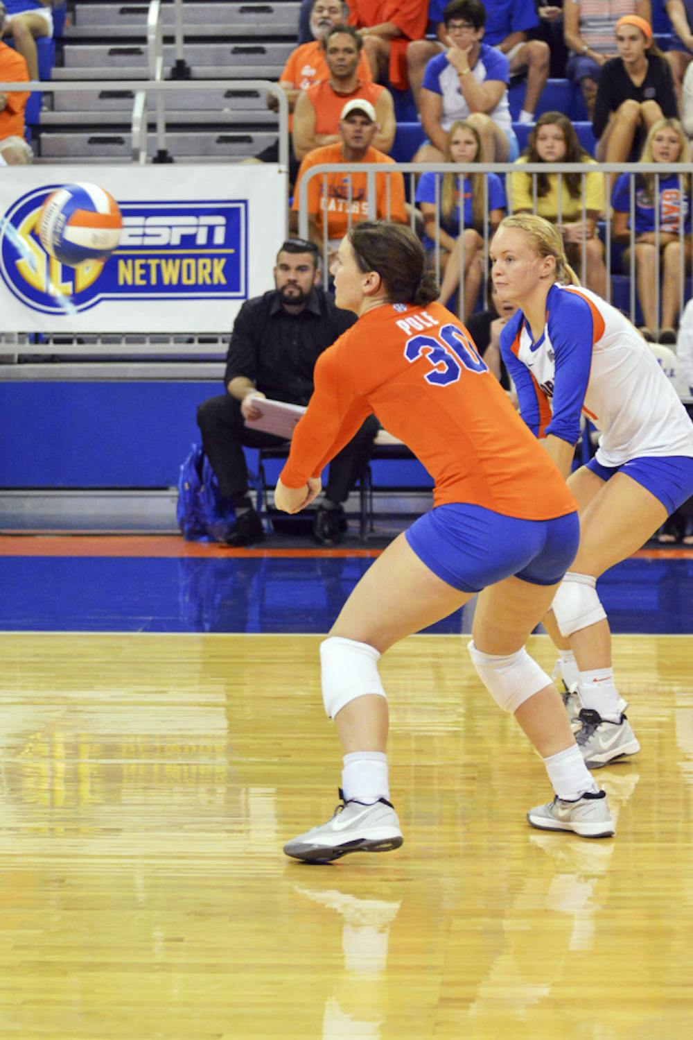 <p>Holly Pole (30) and Maddy Monserez attempt to dig the ball during Florida's 3-0 win against Ole Miss on Sunday in the O'Connell Center.</p>