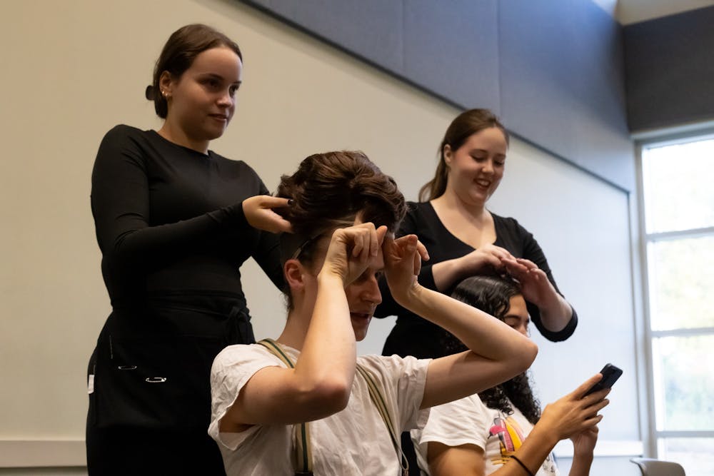 <p>Lead Ethan Garrepy puts on his wig for the Music Man show at the Constanz Theater on Oct. 26 2024.</p>