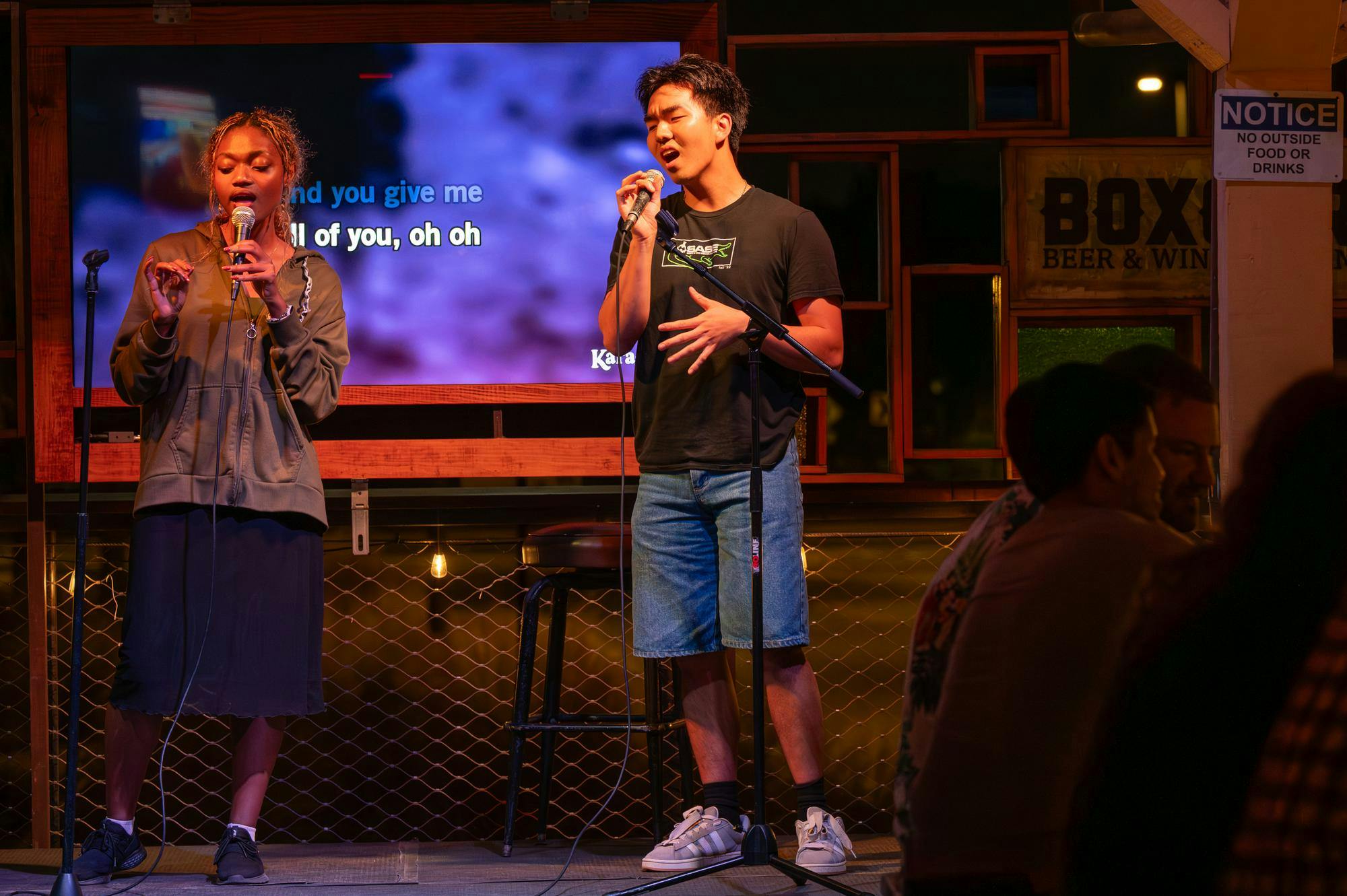 Patrons at Boxcar perform karaoke to “All of Me” by John Legend, Wednesday, Feb. 18, 2026, in Gainesville, Fla.