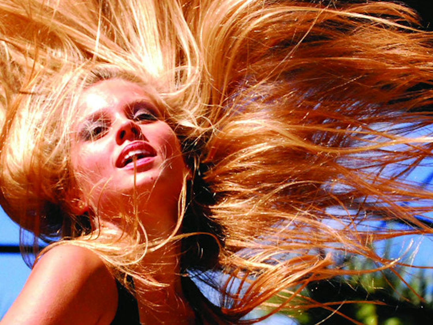 Jessica Stjernvall, a dancer with Sabor Latino, throws her head back during a salsa performance at the Downtown Latino Festival on Saturday. 