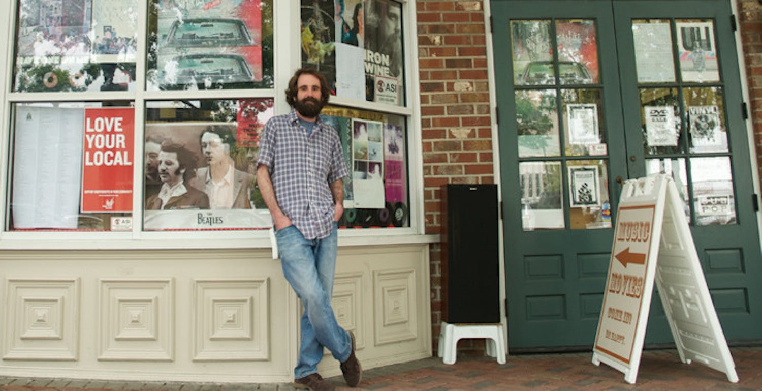 Andrew Schaer, owner of Hear Again Music &amp; Movies, poses for a picture outside his shop at 201SE First St. Schaer has been the go-to provider for Gainesville's increasing vinyl-hungry music listenership.