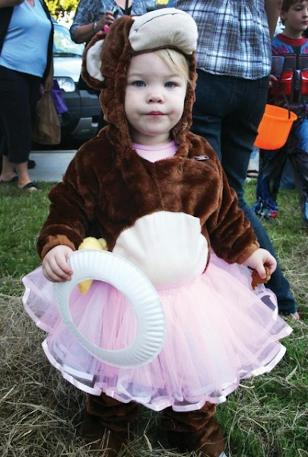 <p>Mackenzie Mavin, 22 months, trick-or-treats outside the Alpha Chi Omega sorority house at Ghouls, Goblins and Greeks on Thursday.</p>
