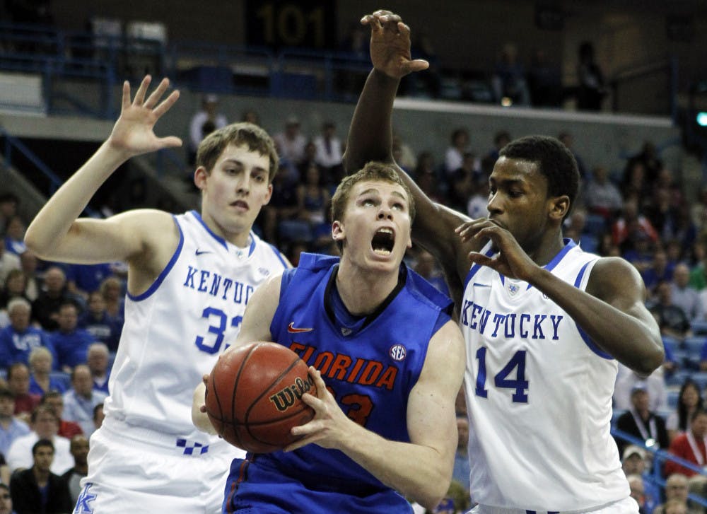 <p>Florida forward/center Erik Murphy (33) goes to the basket as Kentucky forward Michael Kidd-Gilchrist (14) and forward Kyle Wiltjer (33) defend during the first half of the SEC Tournament semifinal Saturday. </p>