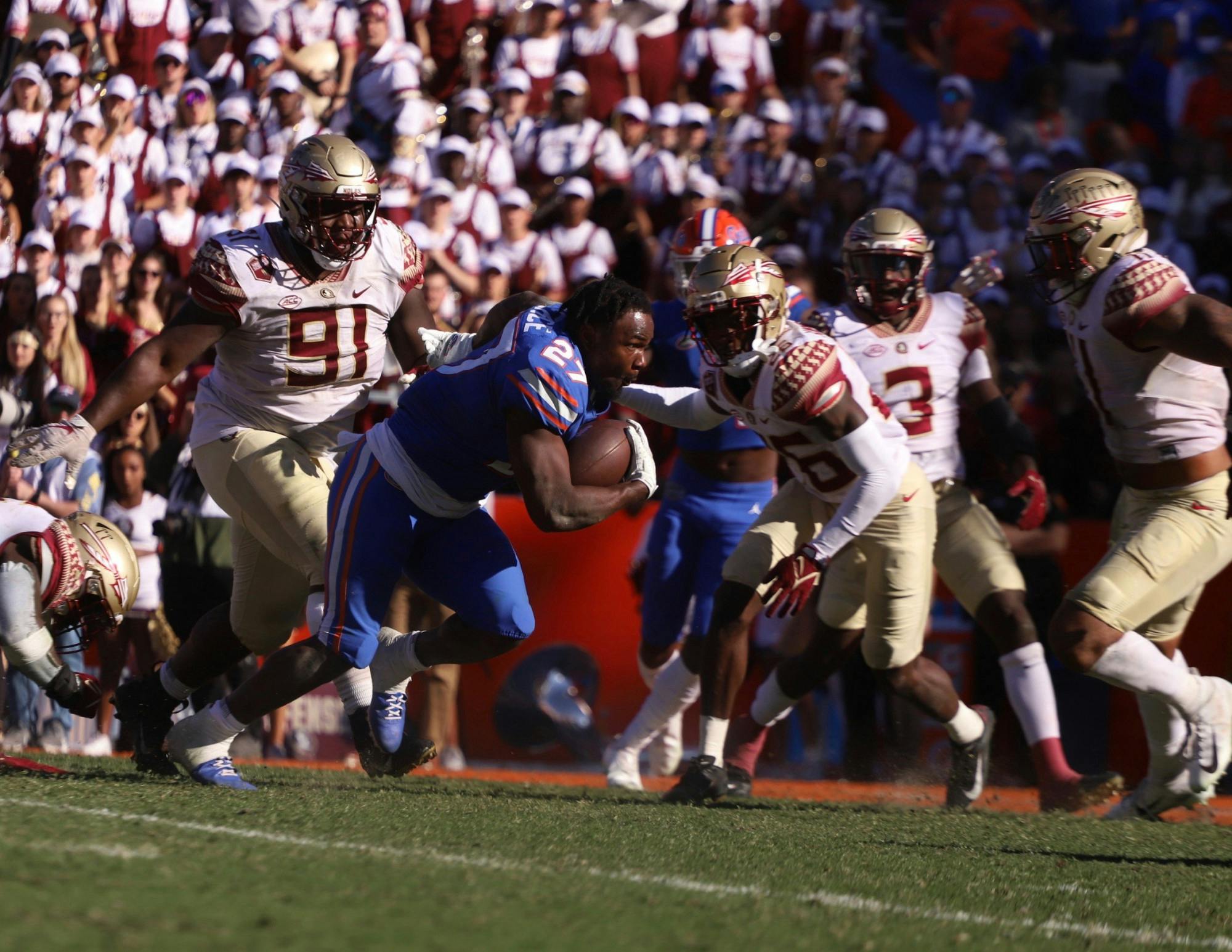 Dameon Pierce runs toward the end zone after losing his helmet during a Nov. 27 game against Florida State. He was drafted in the fourth round of the 2022 NFL Draft by the Houston Texans.
