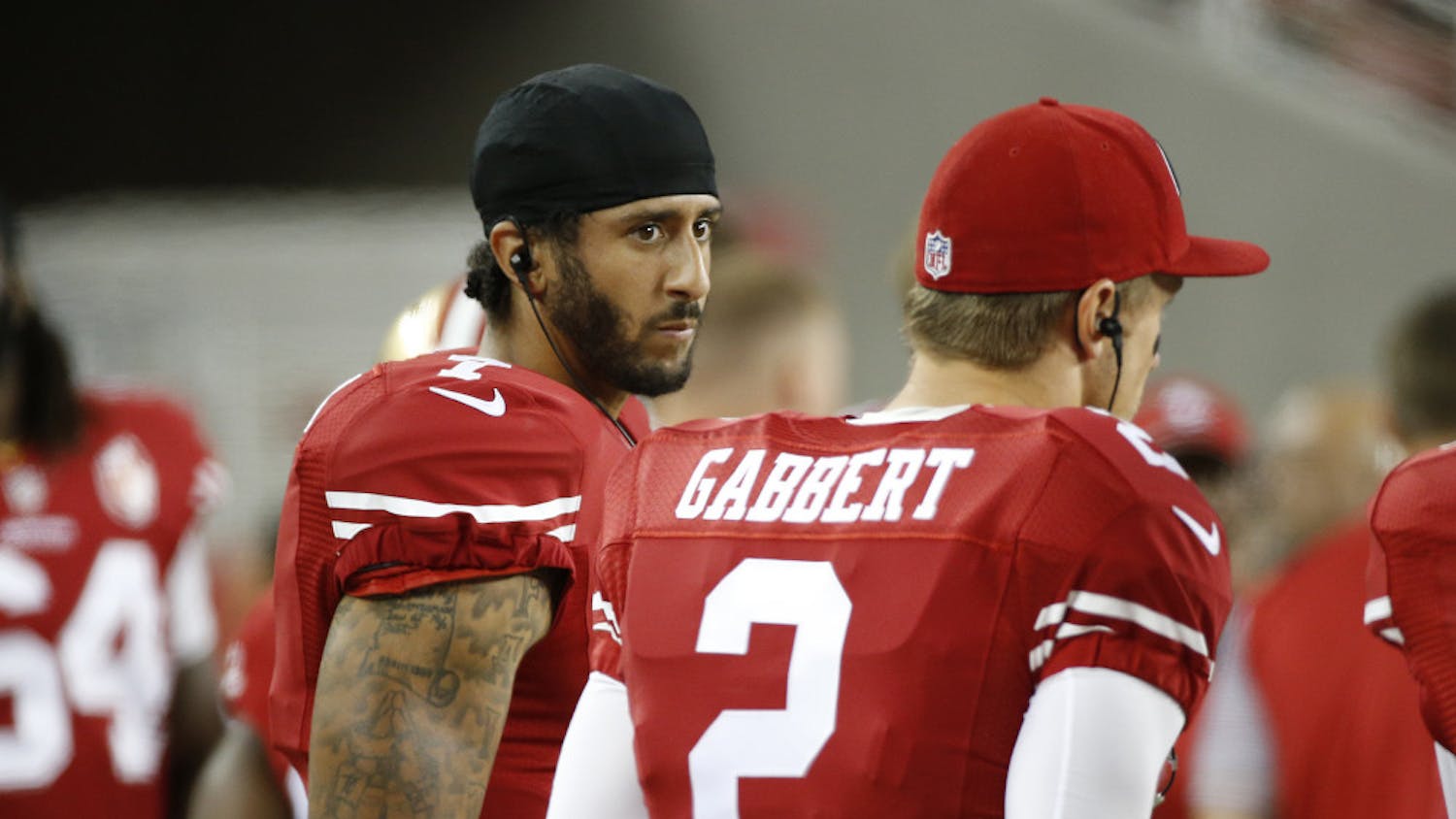 San Francisco 49ers quarterbacks Colin Kaepernick, left, and Blaine Gabbert stand on the sideline during the second half of an NFL preseason football game against the Green Bay Packers on Friday, Aug. 26, 2016, in Santa Clara, Calif. Green Bay won 21-10. (AP Photo/Tony Avelar)