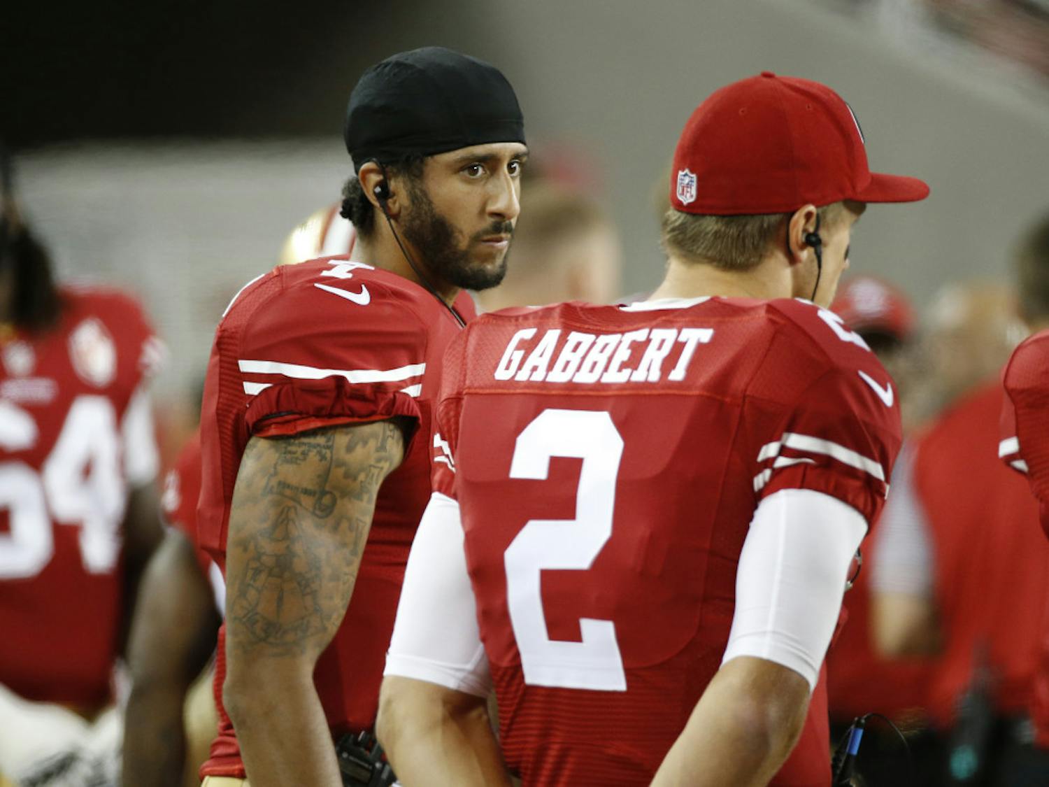 San Francisco 49ers quarterbacks Colin Kaepernick, left, and Blaine Gabbert stand on the sideline during the second half of an NFL preseason football game against the Green Bay Packers on Friday, Aug. 26, 2016, in Santa Clara, Calif. Green Bay won 21-10. (AP Photo/Tony Avelar)