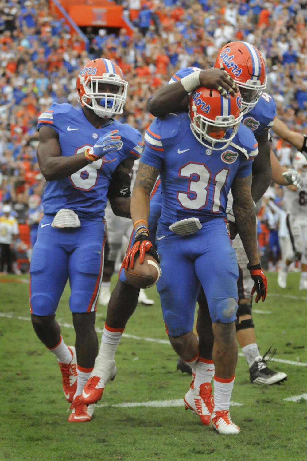<p>Teammates celebrate with cornerback Jalen Tabor after his interception during Florida's 20-14 overtime win against Florida Atlantic on Nov. 21, 2015, at Ben Hill Griffin Stadium.</p>