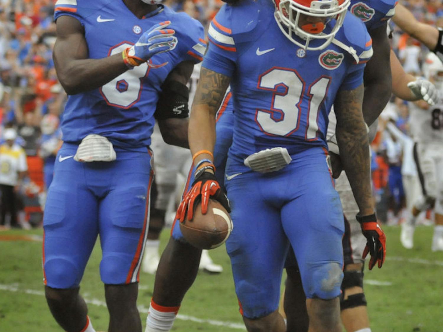 Teammates celebrate with cornerback Jalen Tabor after his interception during Florida's 20-14 overtime win against Florida Atlantic on Nov. 21, 2015, at Ben Hill Griffin Stadium.