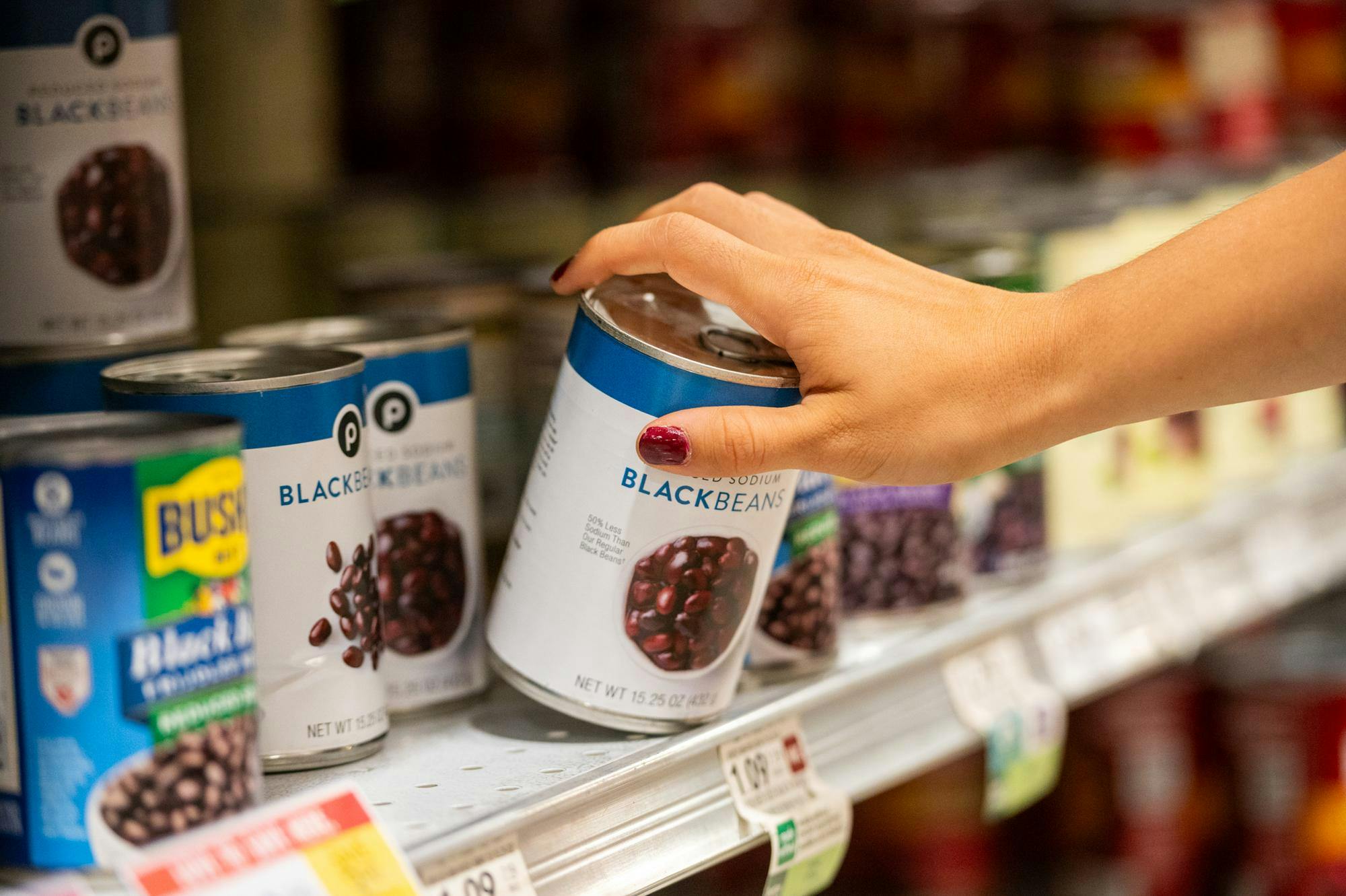 A Publix customer takes a can of black beans off the shelf in Gainesville, Fla., on Sept. 16th 2025.