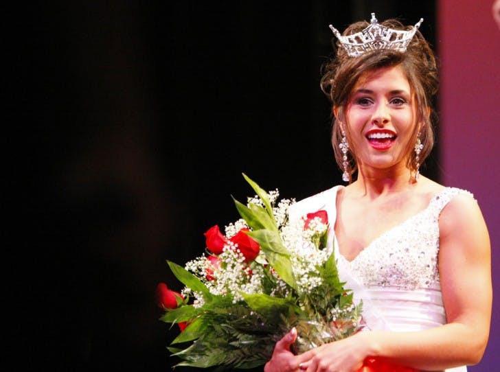 Telecommunication and history sophomore Ashlyn Robinson, the 2012 winner of the Miss University of Florida pageant, stands on the stage of the Phillips Center for the Performing Arts after being crowned on Monday night.