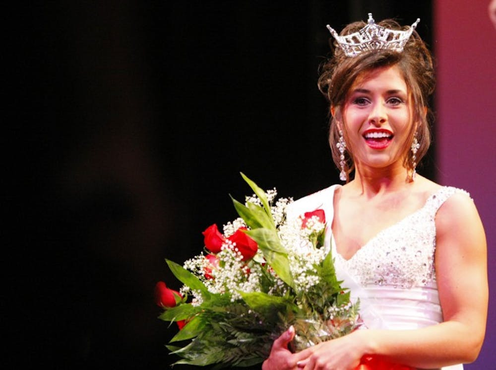 <p>Telecommunication and history sophomore Ashlyn Robinson, the 2012 winner of the Miss University of Florida pageant, stands on the stage of the Phillips Center for the Performing Arts after being crowned on Monday night.</p>