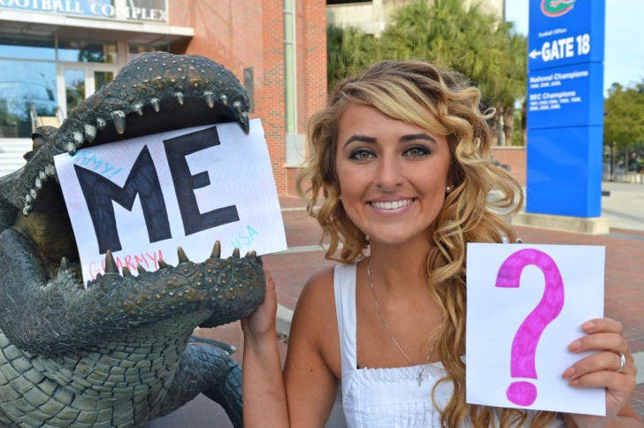 Keira Hornyak poses with some of the signs she used to ask Tim Tebow to the UF Military Ball. Hornyak wants Tebow to help endorse a cystic fibrosis fundraiser.