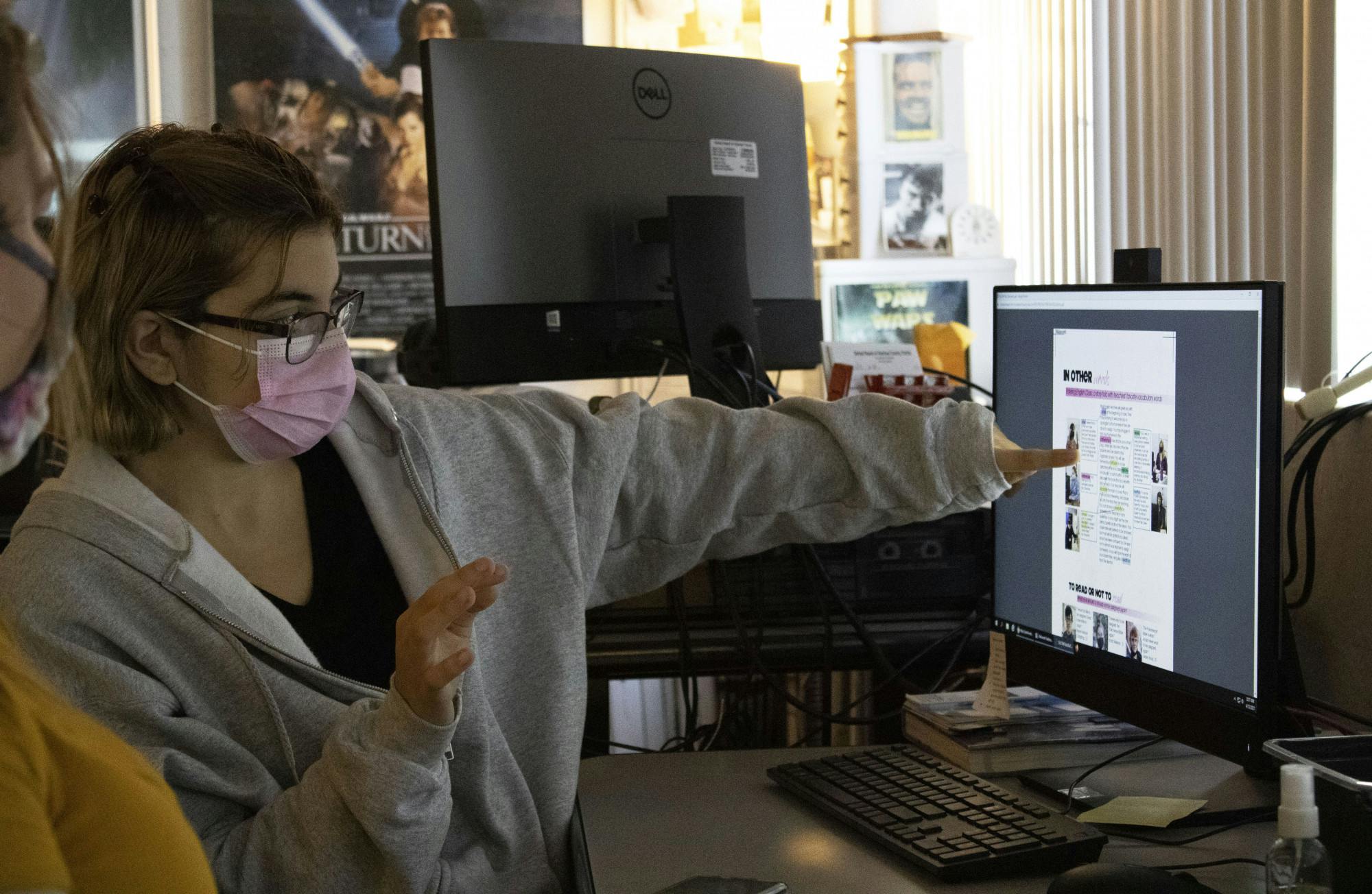 Reyhan Kepic, 18, a senior at Gainesville High School and the editor-in-chief of the school’s yearbook points at a computer screen as she explains the layout of a page spread in the GHS yearbook on Monday, April 12, 2021.