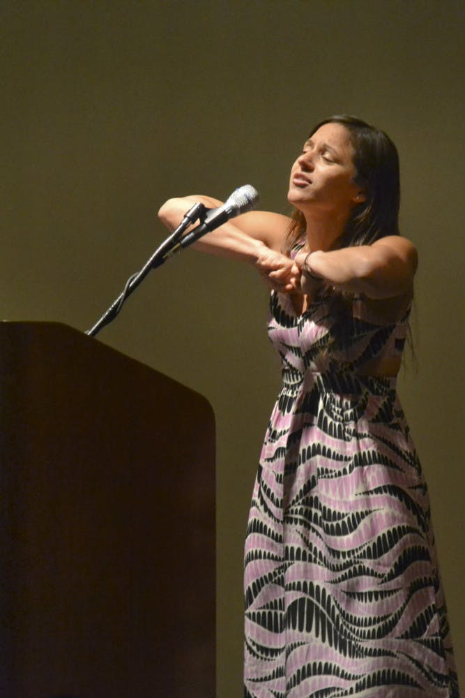 Gabriela Garcia Medina, an international artist and spoken word poet, performs her poem “Self-Empowered Love Poem” during the Hispanic Heritage Month opening ceremony at Emerson Alumni Hall Sept. 14, 2015. Her poem challenged the idea of unhealthy dependent relationships that are promoted in popular music. “I wanted to write a poem of love songs and turn it into something empowering,” Medina said during her speech.
