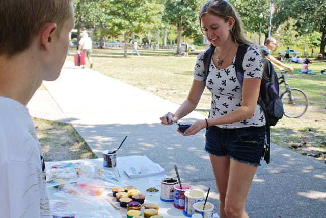 Computer science junior Stephanie Sharp, 20, puts frosting on a free cupcake at UF Pro-Life Alliance's Cupcakes for Life event on the Plaza of the Americas Tuesday.