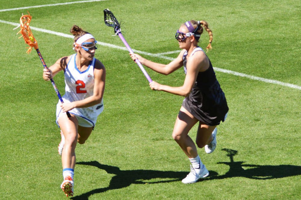 <p>Sammi Burgess drives toward the net during Florida’s 18-7 win against High Point on Feb. 15 at Donald R. Dizney Stadium. The freshman attacker finished second on the team with 53 points.</p>
