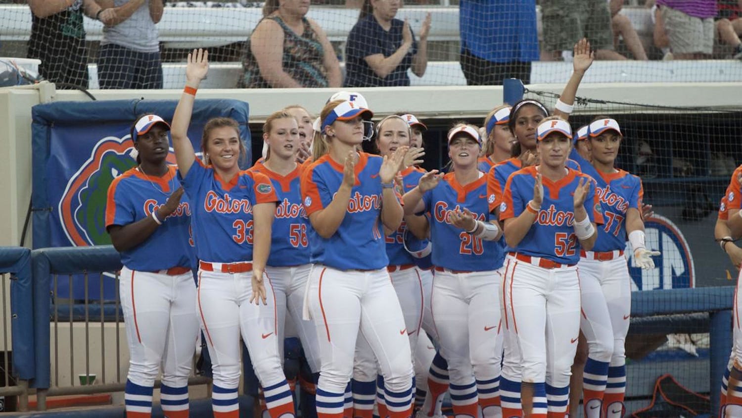 The Gators applaud outside of their dugout during a game last season