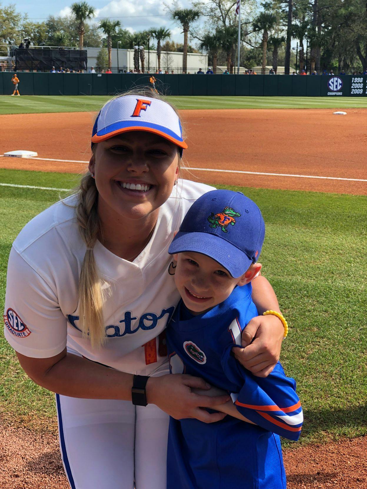 Carter Georges and UF first baseman/left fielder Amanda Lorenz pose before Florida's game against Tennessee on March 10. The Gators defeated the Volunteers 8-0.&nbsp;