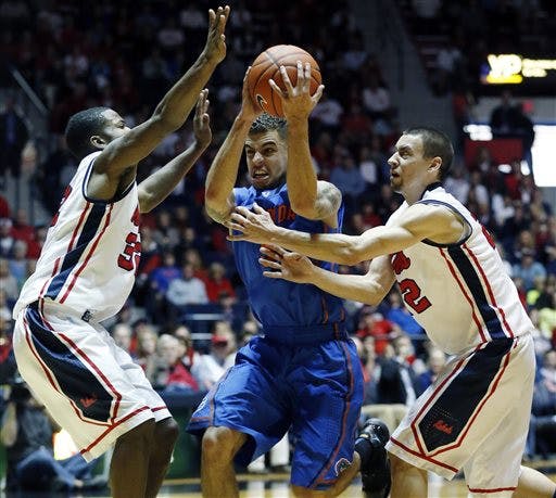 Scottie Wilbekin is guarded by Ole Miss' Jarvis Summers, left, and Marshall Henderson in No. 2 Florida's 75-71 victory on Saturday.