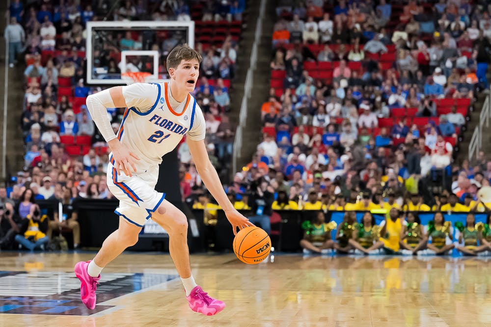 Florida Gators forward/center Alex Condon (21) dribbles the ball during a basketball game against Norfolk State in the first round of the NCAA Tournament on Friday, March 21, 2025, in Raleigh, N.C.