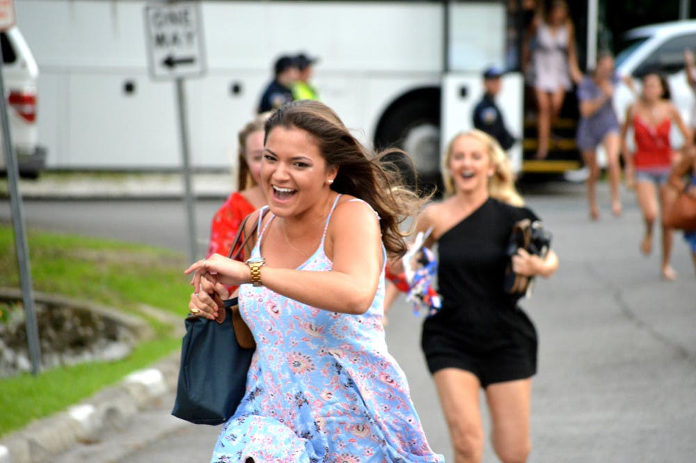 A new member of the Kappa Delta Sorority sprints toward the house on Fall Bid Day 2017.