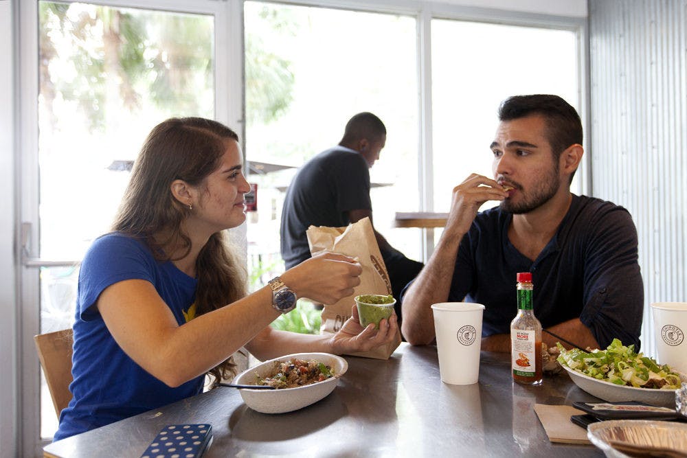 <p>Lina Mejia (left), 21, and Nicholas Acosta, 22, both UF architecture juniors, eat chips and guacamole at Chipotle on West University Avenue on Sept. 1, 2015.&nbsp;</p>