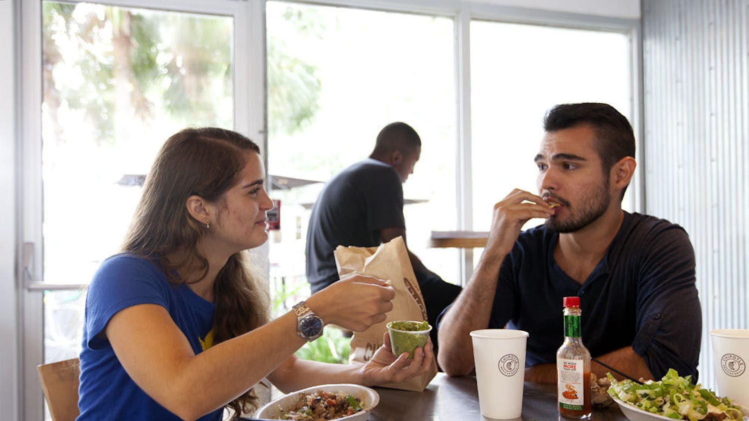 Lina Mejia (left), 21, and Nicholas Acosta, 22, both UF architecture juniors, eat chips and guacamole at Chipotle on West University Avenue on Sept. 1, 2015. 