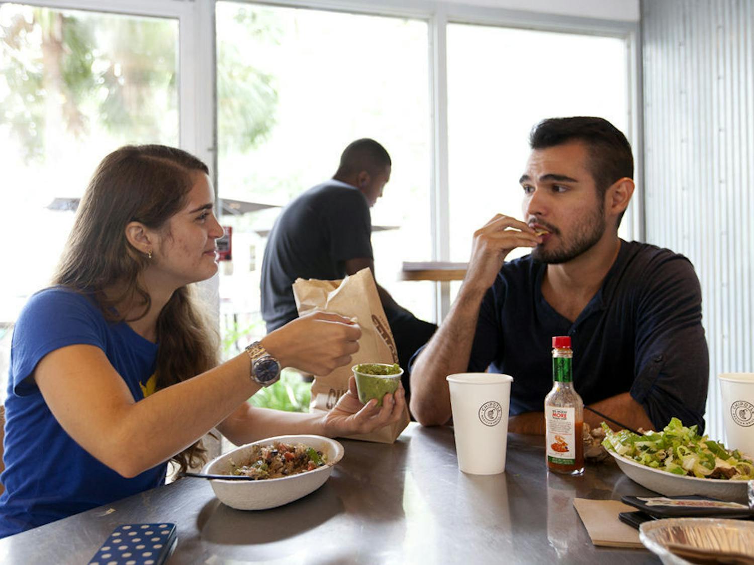 Lina Mejia (left), 21, and Nicholas Acosta, 22, both UF architecture juniors, eat chips and guacamole at Chipotle on West University Avenue on Sept. 1, 2015.&nbsp;
